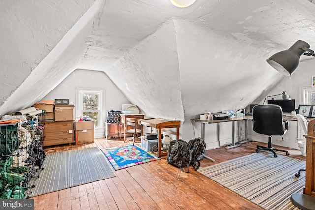 office space featuring lofted ceiling and hardwood / wood-style floors