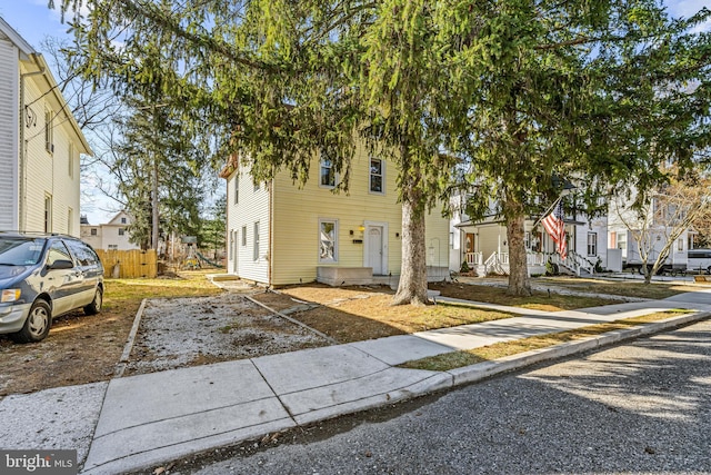 view of front of house featuring a residential view and fence