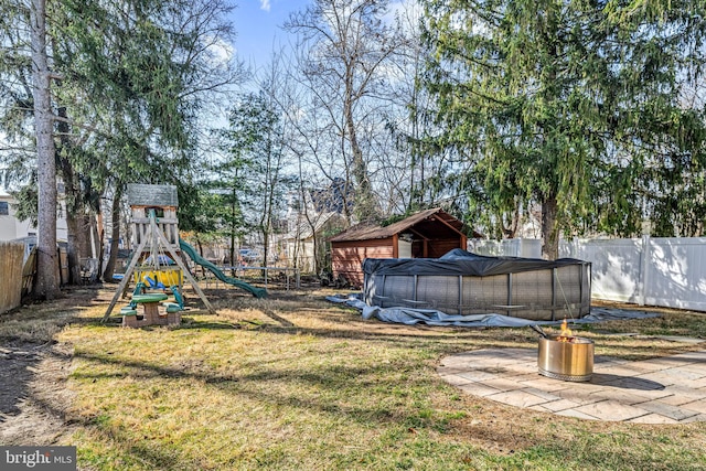 view of yard with a pool, a playground, and a fenced backyard