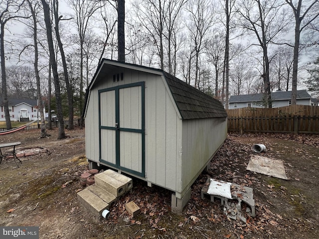 view of shed featuring fence