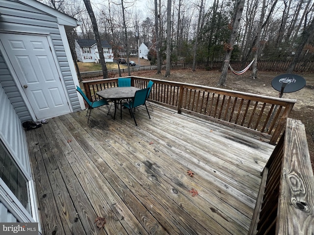 wooden deck with outdoor dining area and fence