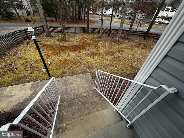 exterior space featuring fence and a residential view