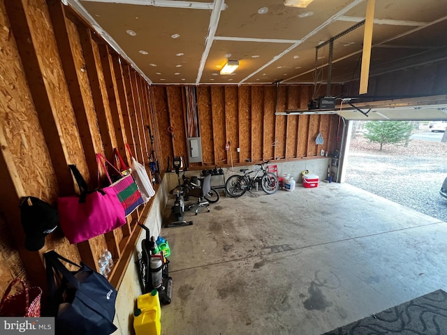 garage with electric panel and a garage door opener