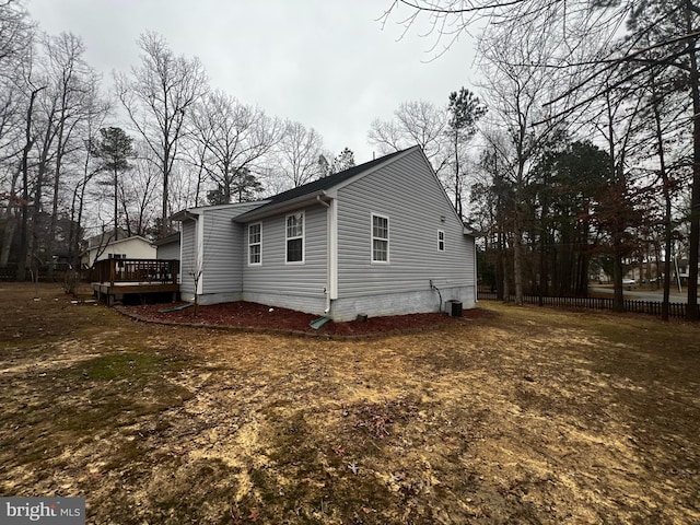 view of side of home featuring central air condition unit and a deck