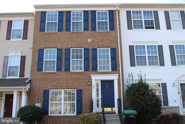 townhome / multi-family property with brick siding