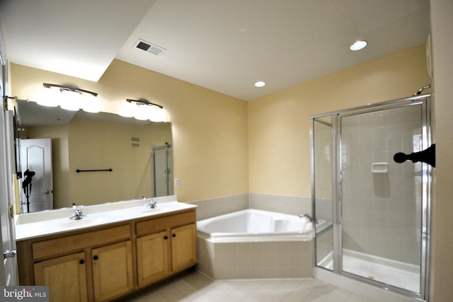 full bathroom with a shower stall, a garden tub, visible vents, and a sink