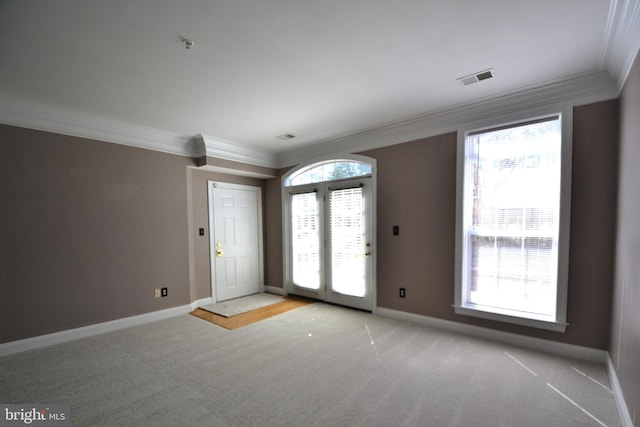 interior space with visible vents, carpet flooring, baseboards, and ornamental molding