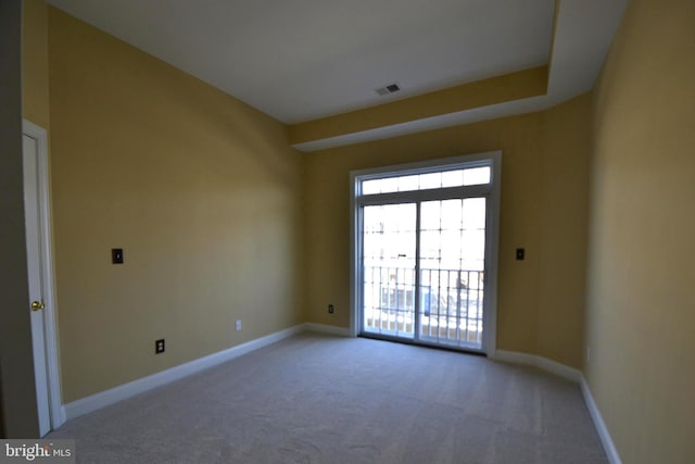 empty room featuring carpet flooring, baseboards, and visible vents