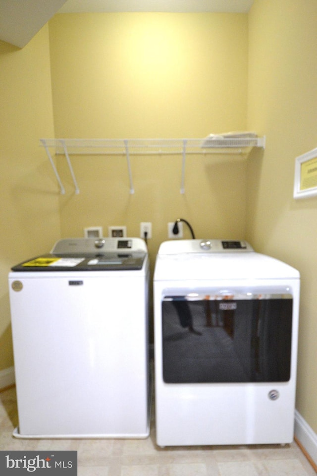 laundry area with washing machine and clothes dryer and laundry area