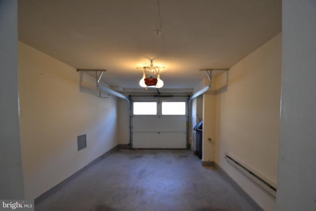 garage featuring a garage door opener and a baseboard radiator