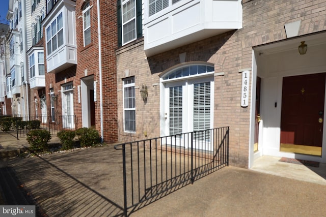 doorway to property with brick siding and a residential view