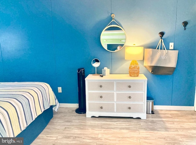 bedroom with light wood-style floors and baseboards