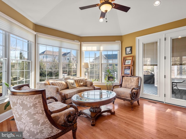 sunroom / solarium featuring visible vents, ceiling fan, and vaulted ceiling