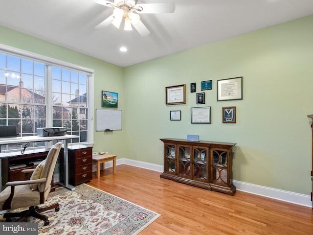 office featuring light wood finished floors, recessed lighting, baseboards, and ceiling fan