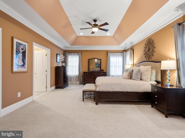 bedroom featuring light carpet, multiple windows, a raised ceiling, and ornamental molding