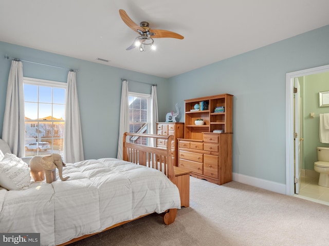 bedroom with baseboards, visible vents, ceiling fan, ensuite bathroom, and carpet flooring