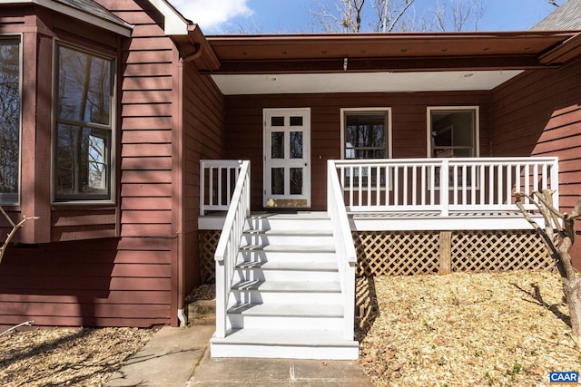 view of exterior entry featuring a porch