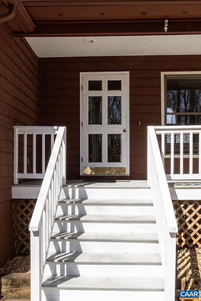 view of exterior entry with covered porch