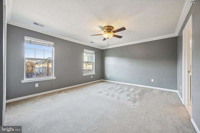 unfurnished room with visible vents, ceiling fan, crown molding, and baseboards