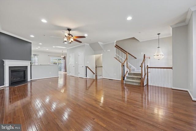 unfurnished living room with a fireplace with flush hearth, recessed lighting, and wood-type flooring