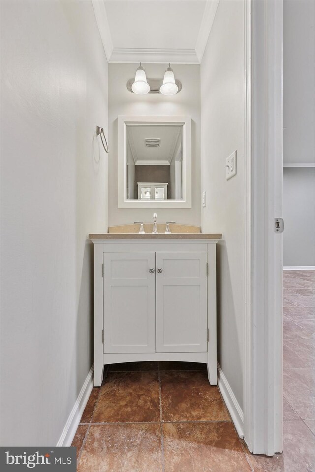 bathroom with vanity, visible vents, baseboards, and ornamental molding