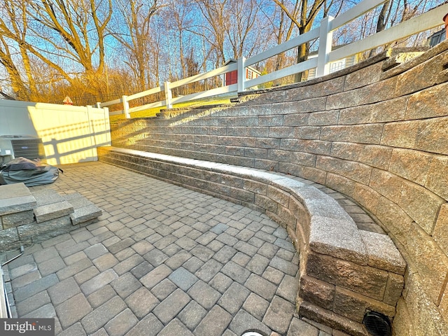 view of patio / terrace with cooling unit and fence