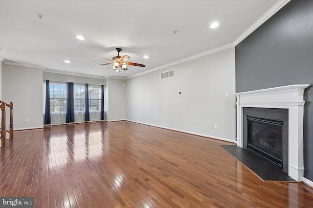 unfurnished living room featuring visible vents, a fireplace with flush hearth, baseboards, and hardwood / wood-style flooring