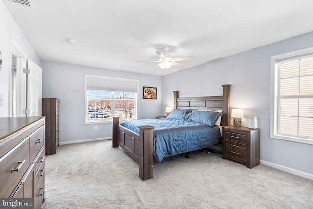 bedroom featuring light carpet, visible vents, ceiling fan, and baseboards