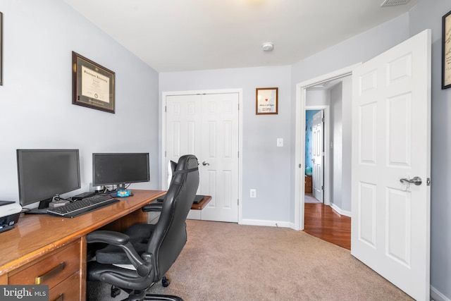 carpeted home office with visible vents and baseboards