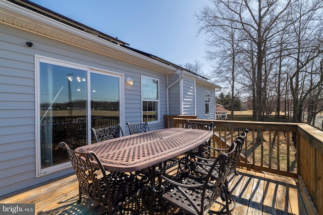 wooden terrace featuring outdoor dining space