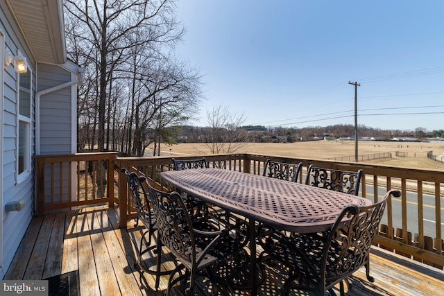 wooden terrace featuring outdoor dining area