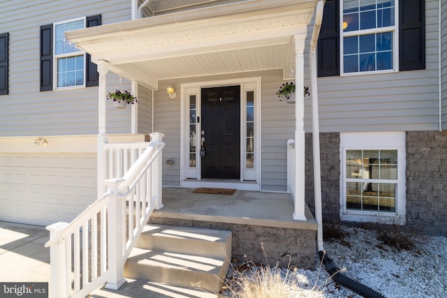 property entrance with a garage and a porch