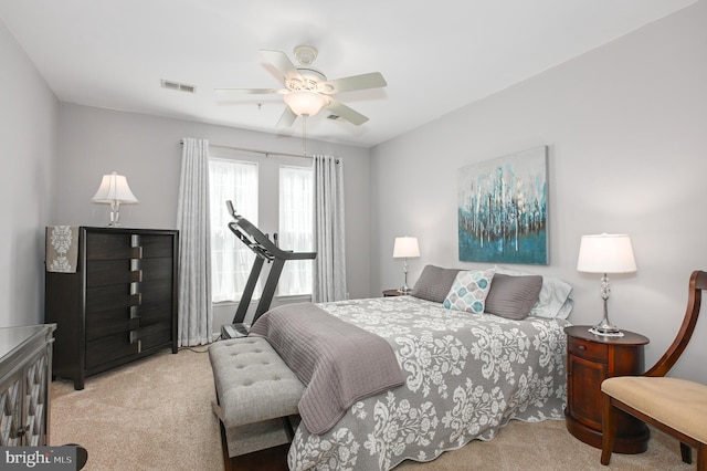 carpeted bedroom with visible vents and a ceiling fan