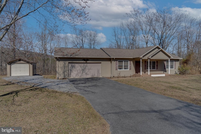 ranch-style home with aphalt driveway, an attached garage, a shingled roof, and a front yard