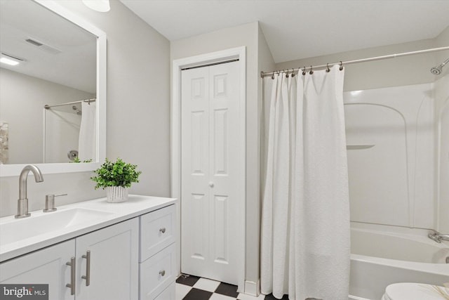 full bathroom with vanity, visible vents, shower / bath combo with shower curtain, tile patterned floors, and toilet