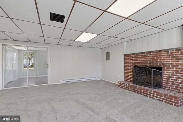 unfurnished living room with visible vents, electric panel, baseboard heating, carpet flooring, and a fireplace