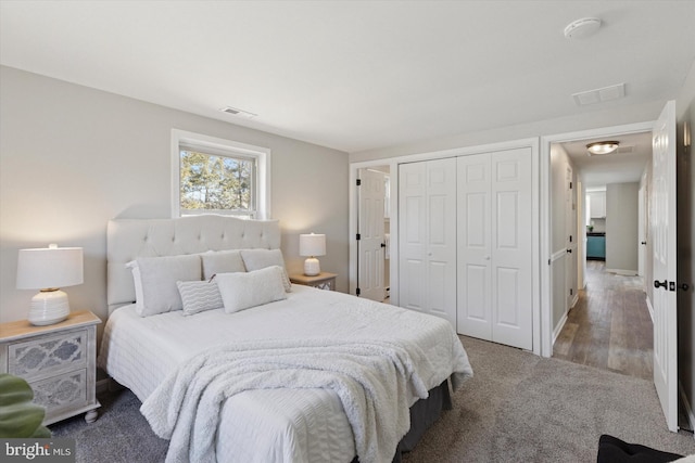 carpeted bedroom with a closet and visible vents