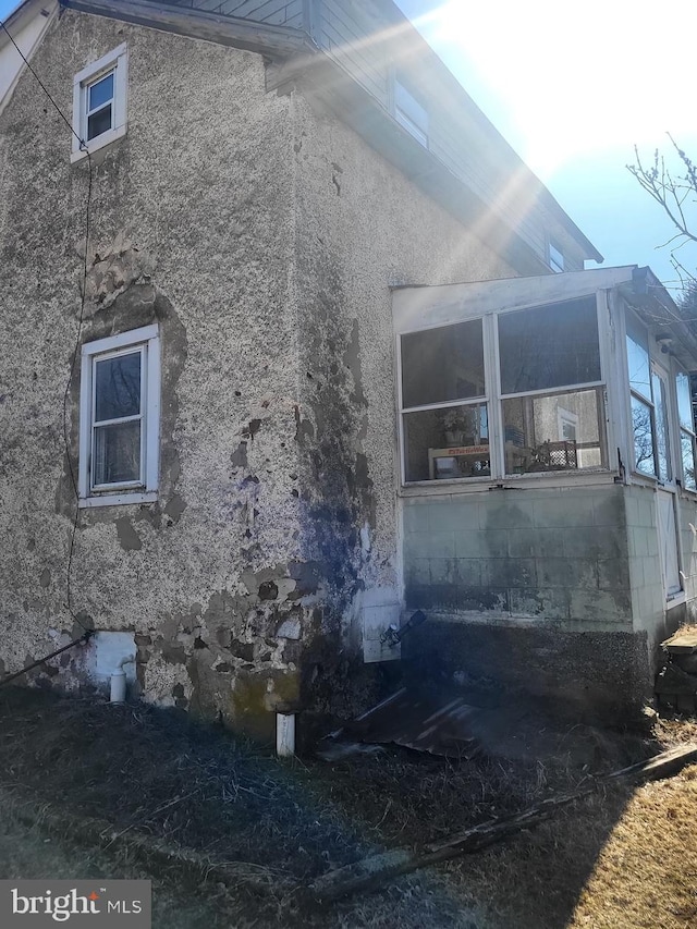 view of side of home featuring stucco siding