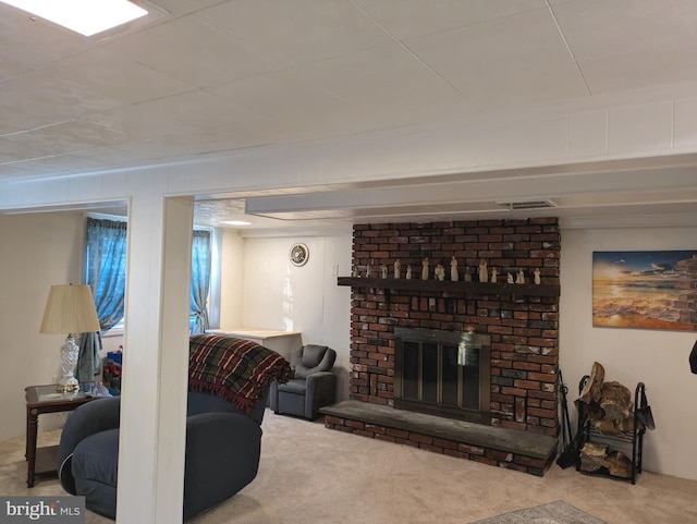 carpeted living room with visible vents and a brick fireplace