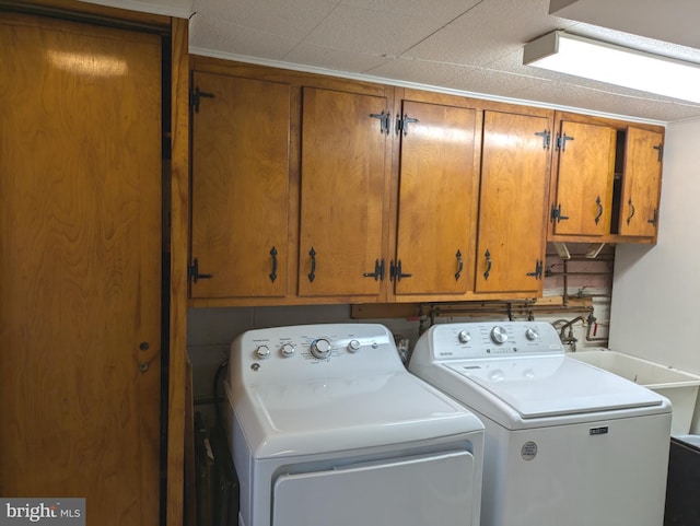 laundry area with washer and clothes dryer and cabinet space