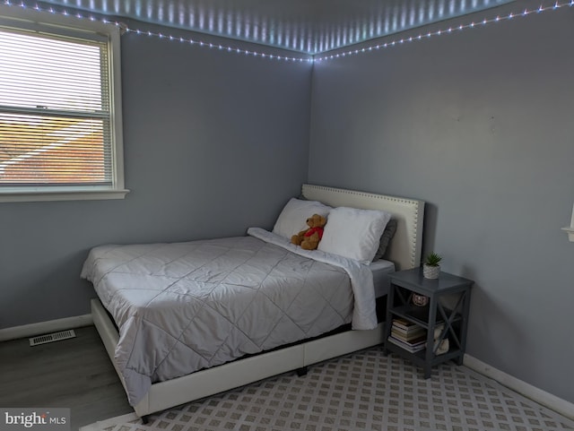 bedroom with baseboards and visible vents