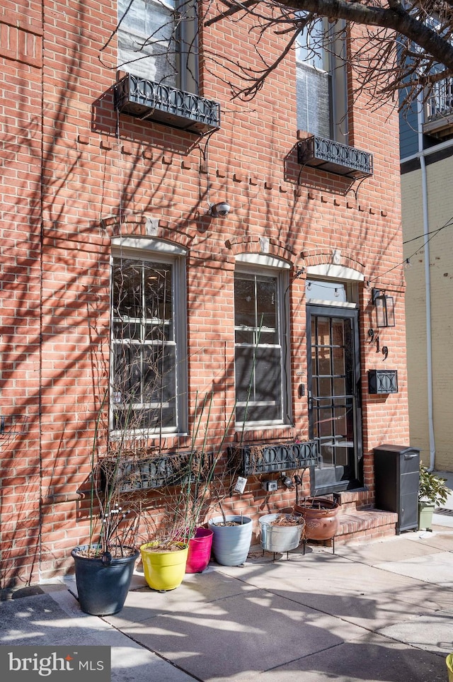 property entrance with brick siding