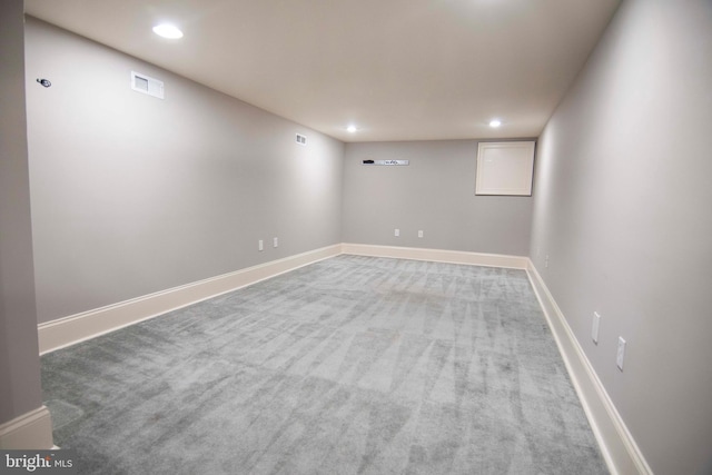 finished below grade area with recessed lighting, visible vents, baseboards, and carpet