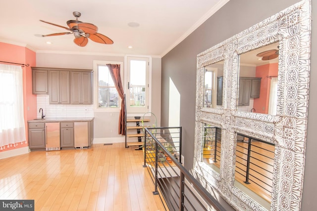 interior space featuring a wealth of natural light, light wood-style flooring, and ornamental molding