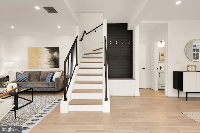 staircase featuring visible vents, recessed lighting, and wood finished floors