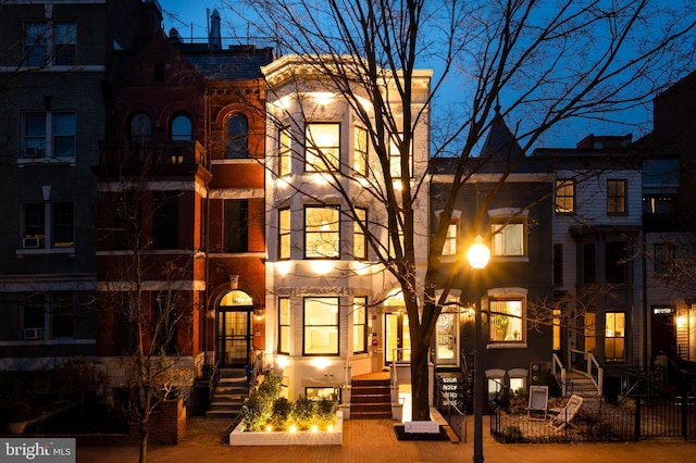 rear view of house featuring a fenced front yard