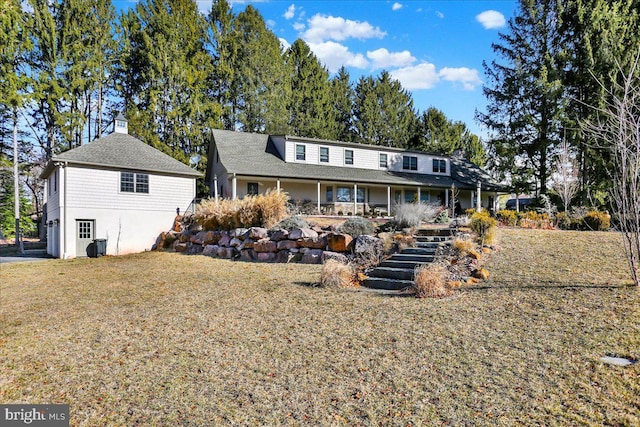 rear view of house with a yard and stairs