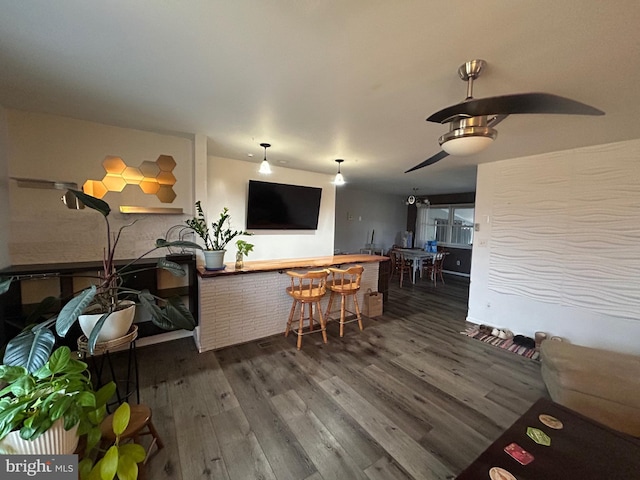 living room with a bar and wood finished floors