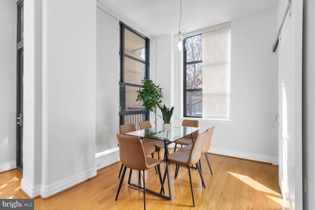 dining area with light wood finished floors and baseboards