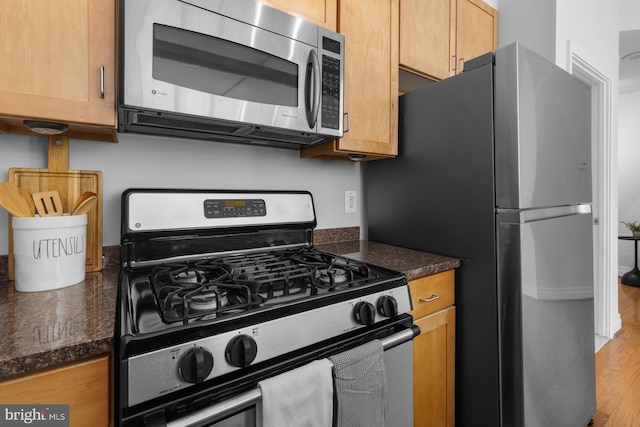 kitchen featuring appliances with stainless steel finishes and wood finished floors